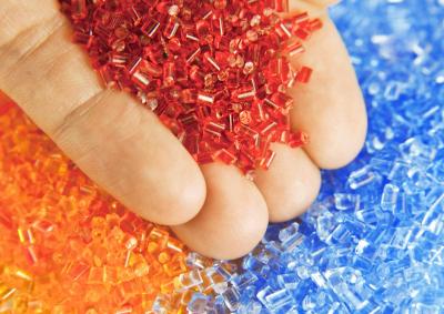 Hand holding polymer plastic granules